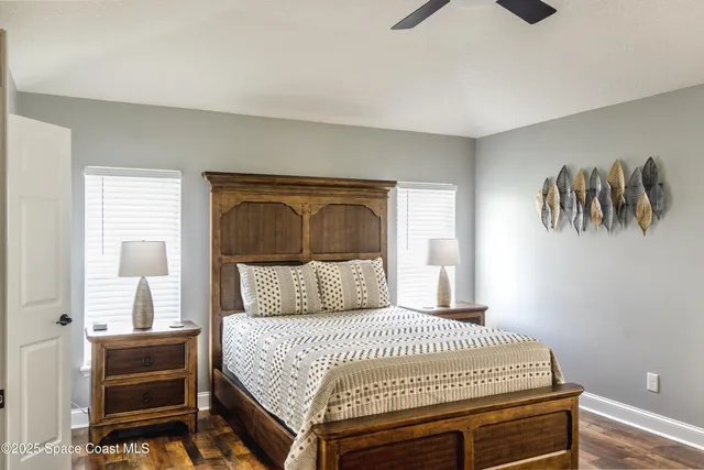 a bedroom with a bed and a painting on the wall