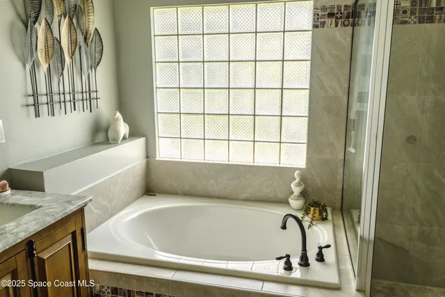 a bathroom with a tub and shower