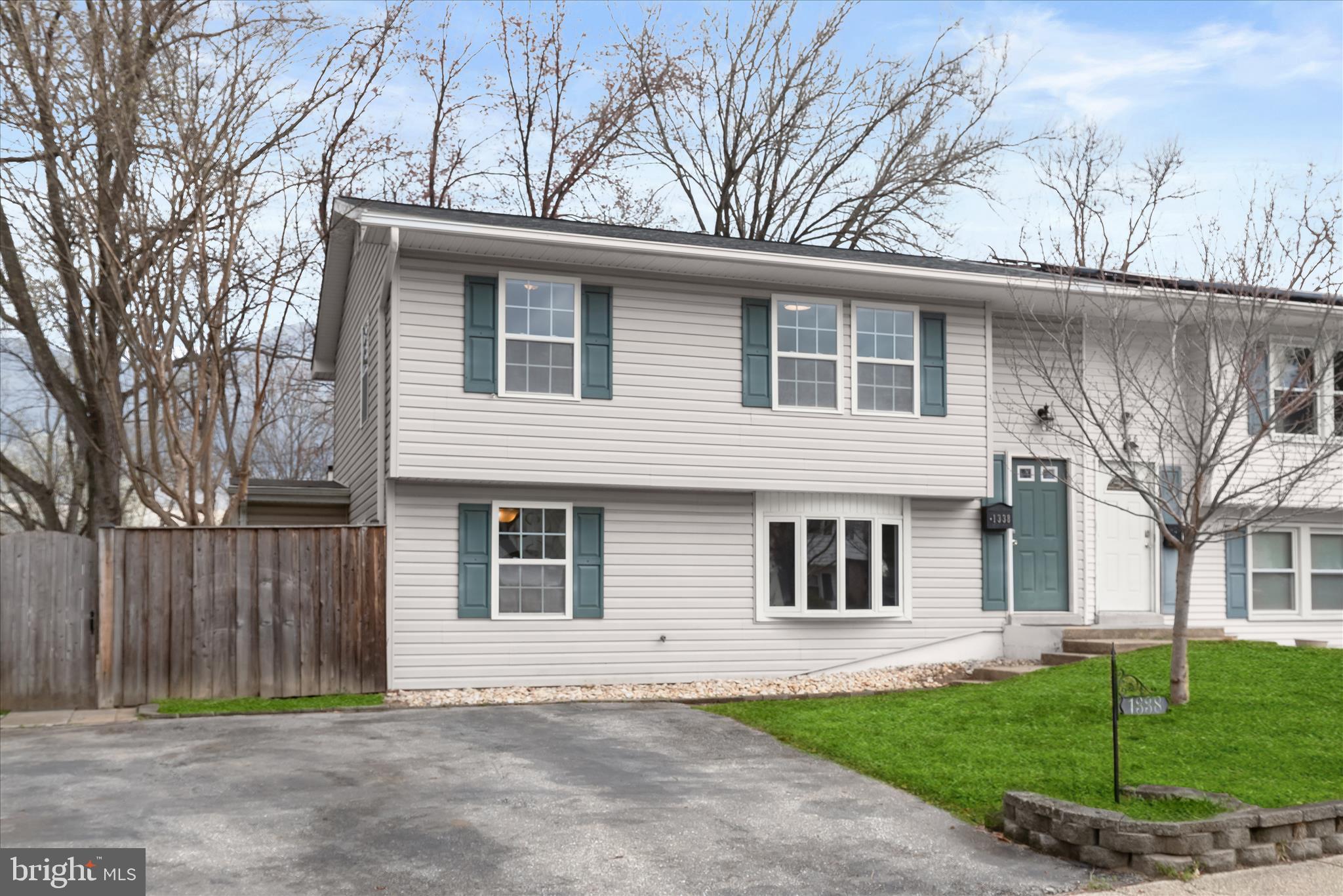 1338 Hallock Drive Odenton, MD 21113 - Photo 1 of 1 a front view of a house with a garden and trees