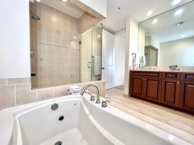 a bathroom with a tub sink and mirror