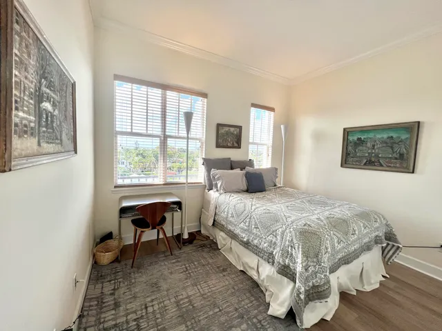 a bedroom with a bed a table and chair