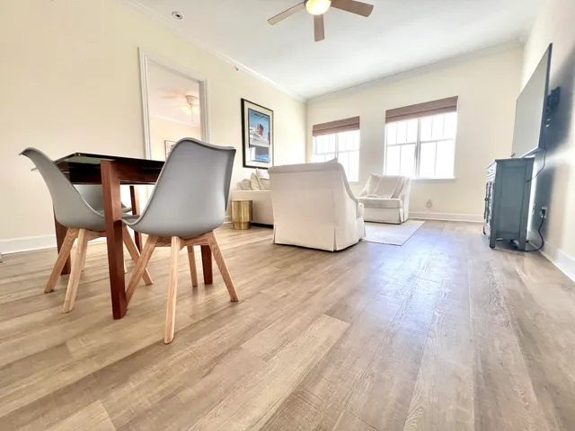 a living room with furniture and a wooden floor