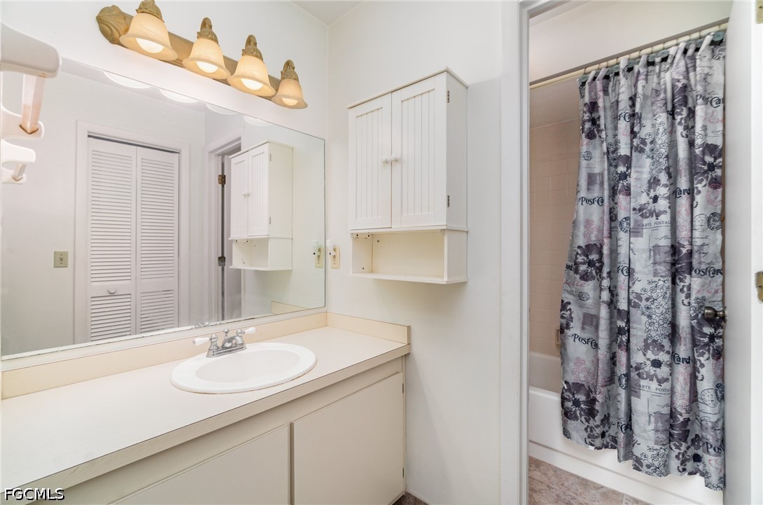 10615 Roxbury Court Lehigh Acres, FL 33936 - Photo 17 of 33 a bathroom with a sink double vanity and a mirror