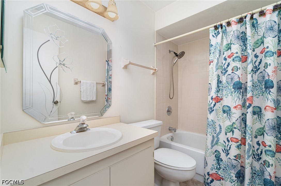 10615 Roxbury Court Lehigh Acres, FL 33936 - Photo 20 of 33 a bathroom with a sink toilet and shower curtain