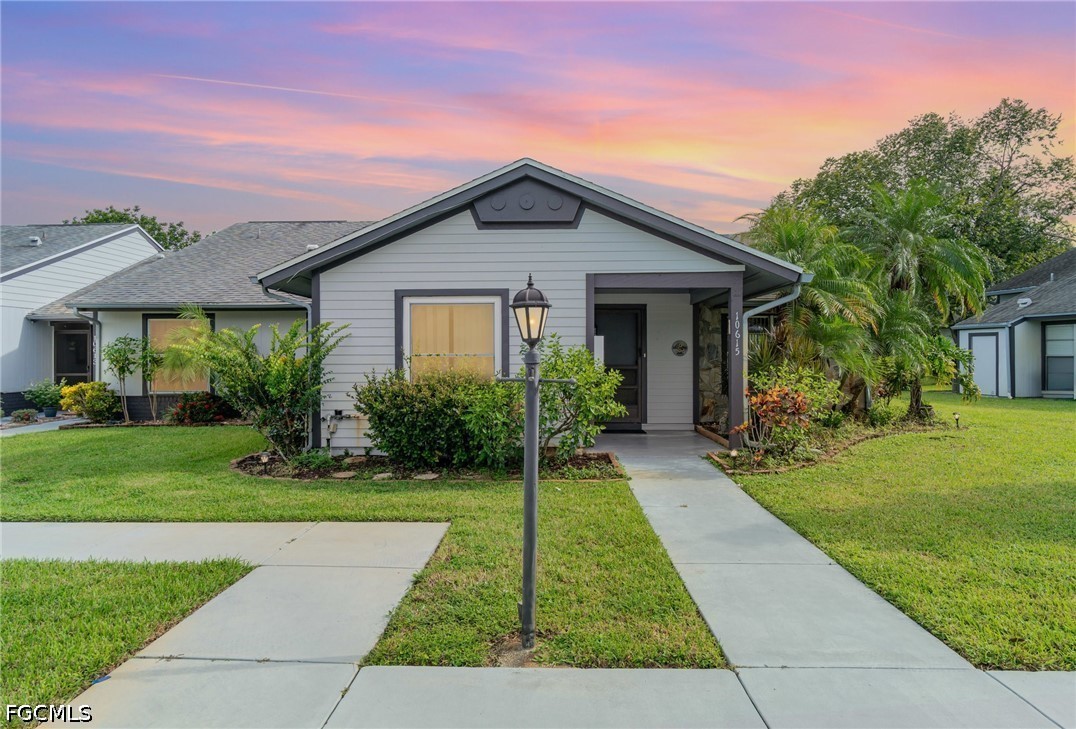 10615 Roxbury Court Lehigh Acres, FL 33936 - Photo 26 of 33 a view of a house with a yard