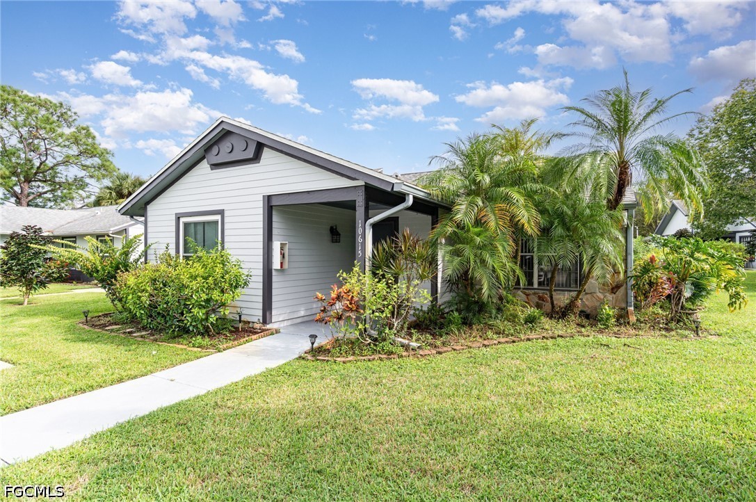 10615 Roxbury Court Lehigh Acres, FL 33936 - Photo 3 of 33 a front view of house with yard and green space