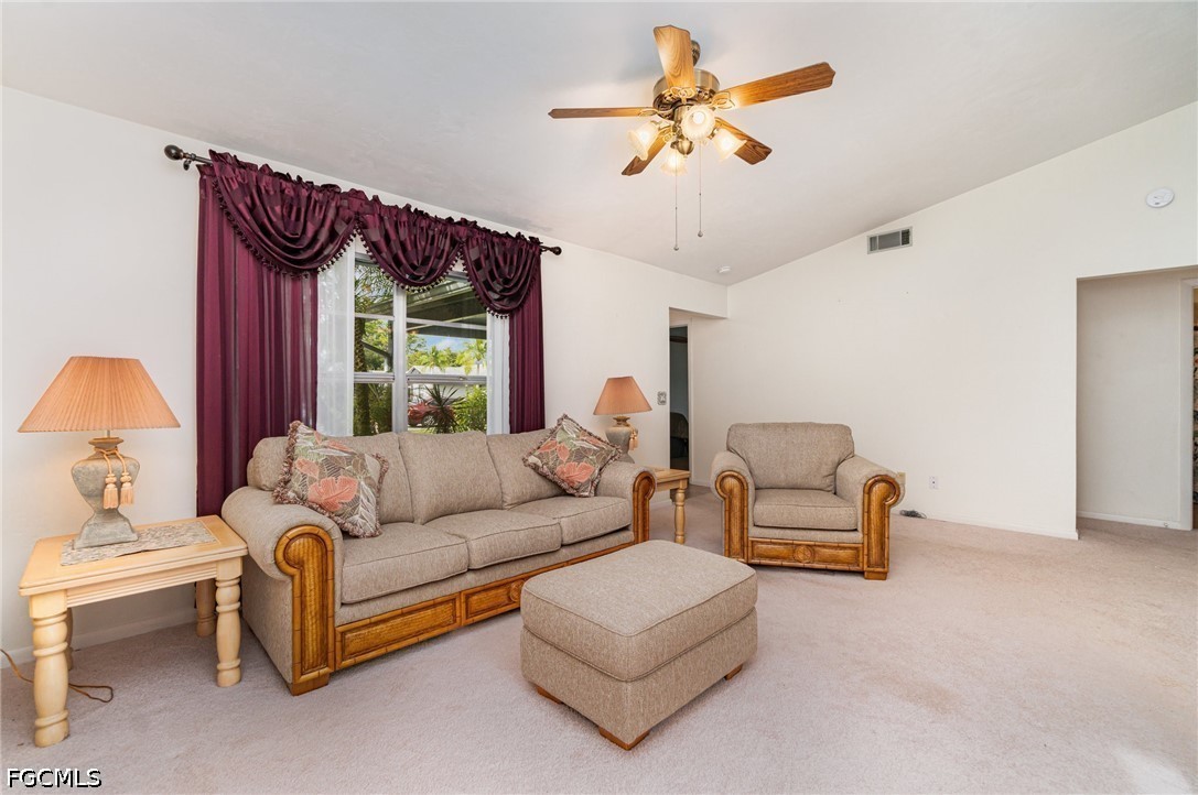 10615 Roxbury Court Lehigh Acres, FL 33936 - Photo 5 of 33 a living room with furniture ceiling fan and a rug