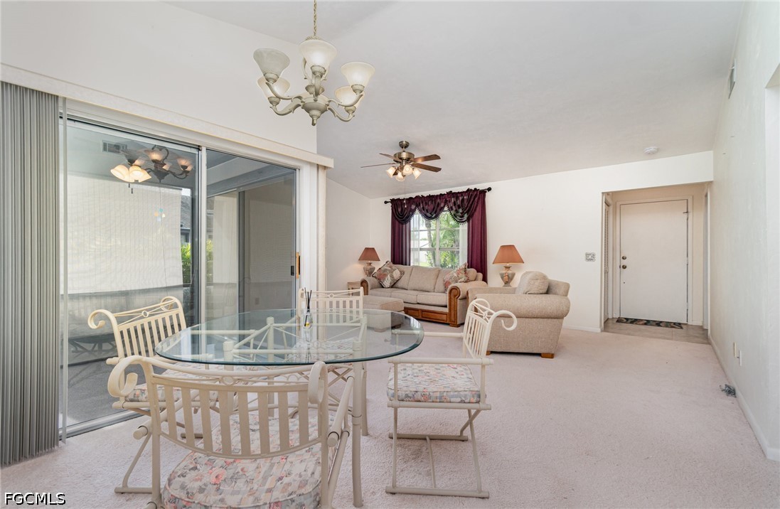 10615 Roxbury Court Lehigh Acres, FL 33936 - Photo 8 of 33 a living room with fireplace furniture and a chandelier