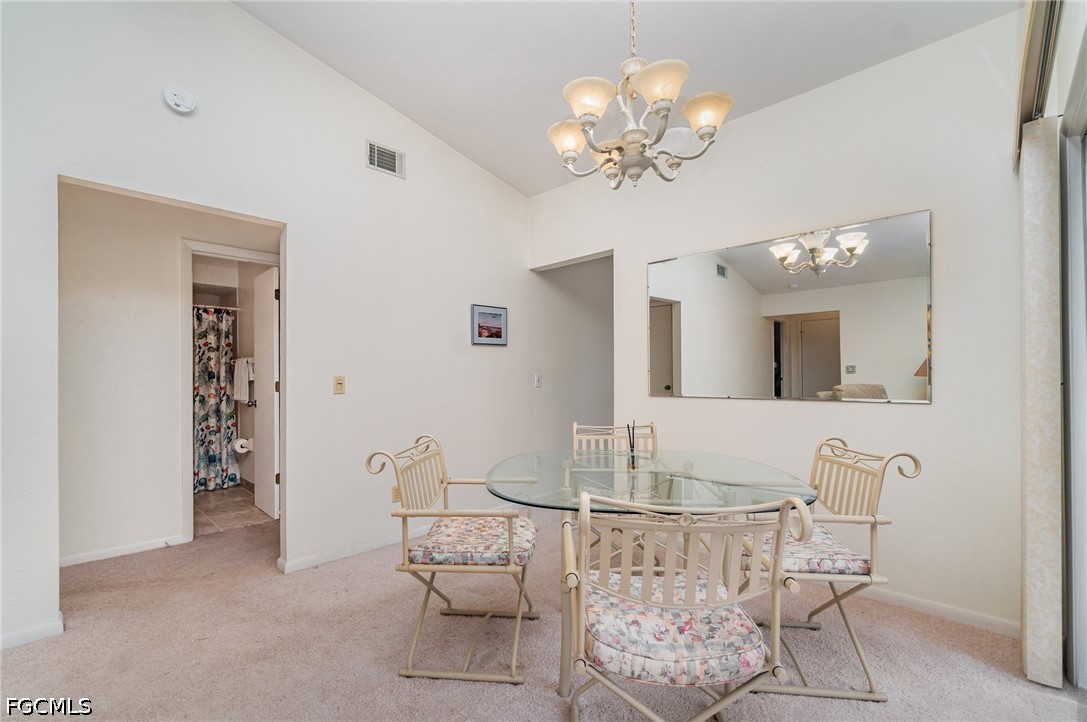 10615 Roxbury Court Lehigh Acres, FL 33936 - Photo 9 of 33 a view of a dining room with furniture and chandelier