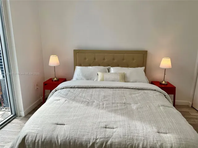 a bedroom with a bed and a night stand