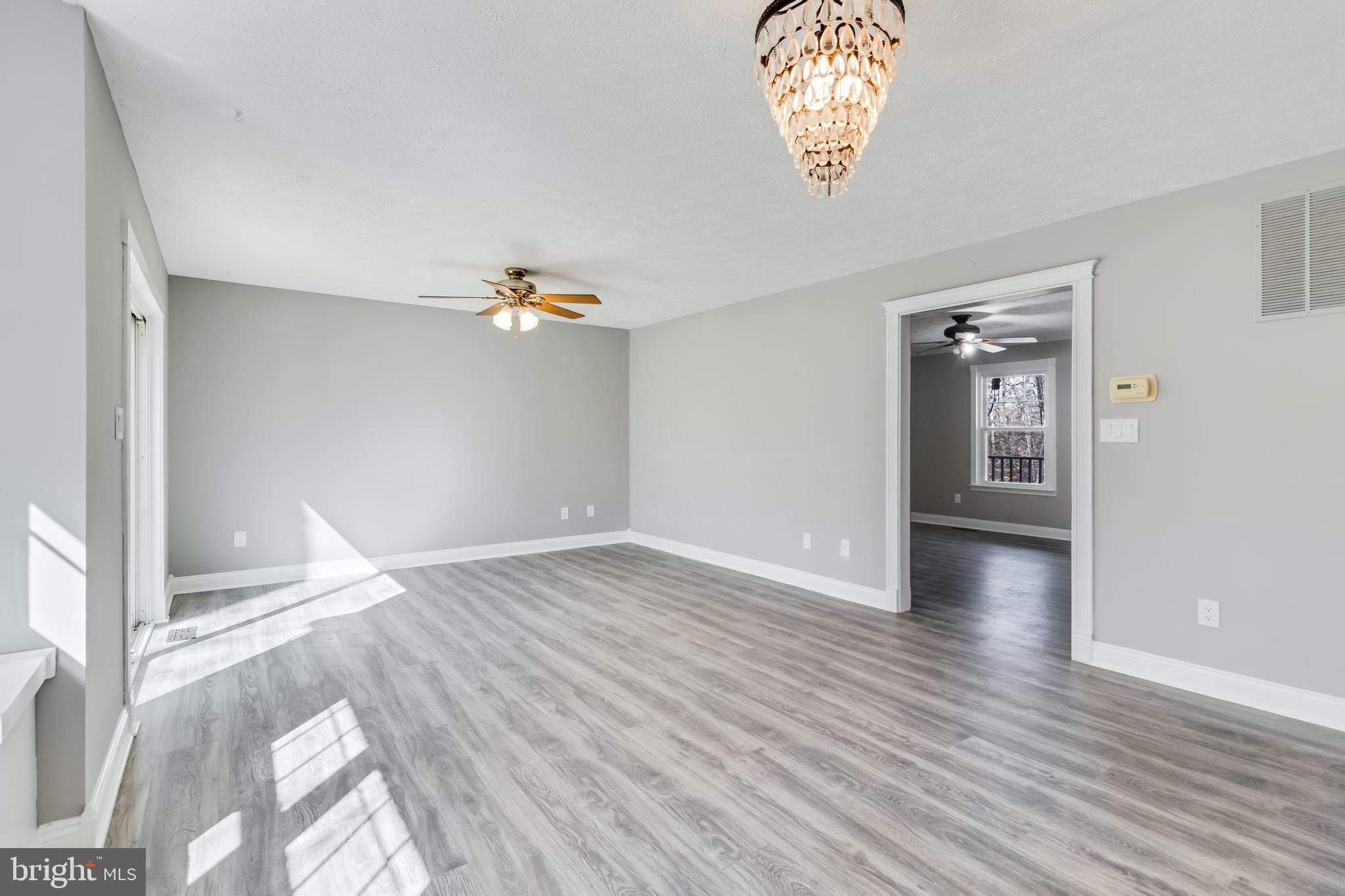 648 Santa Fe Trail Lusby, MD 20657 - Photo 11 of 58 wooden floor in an empty room with a window