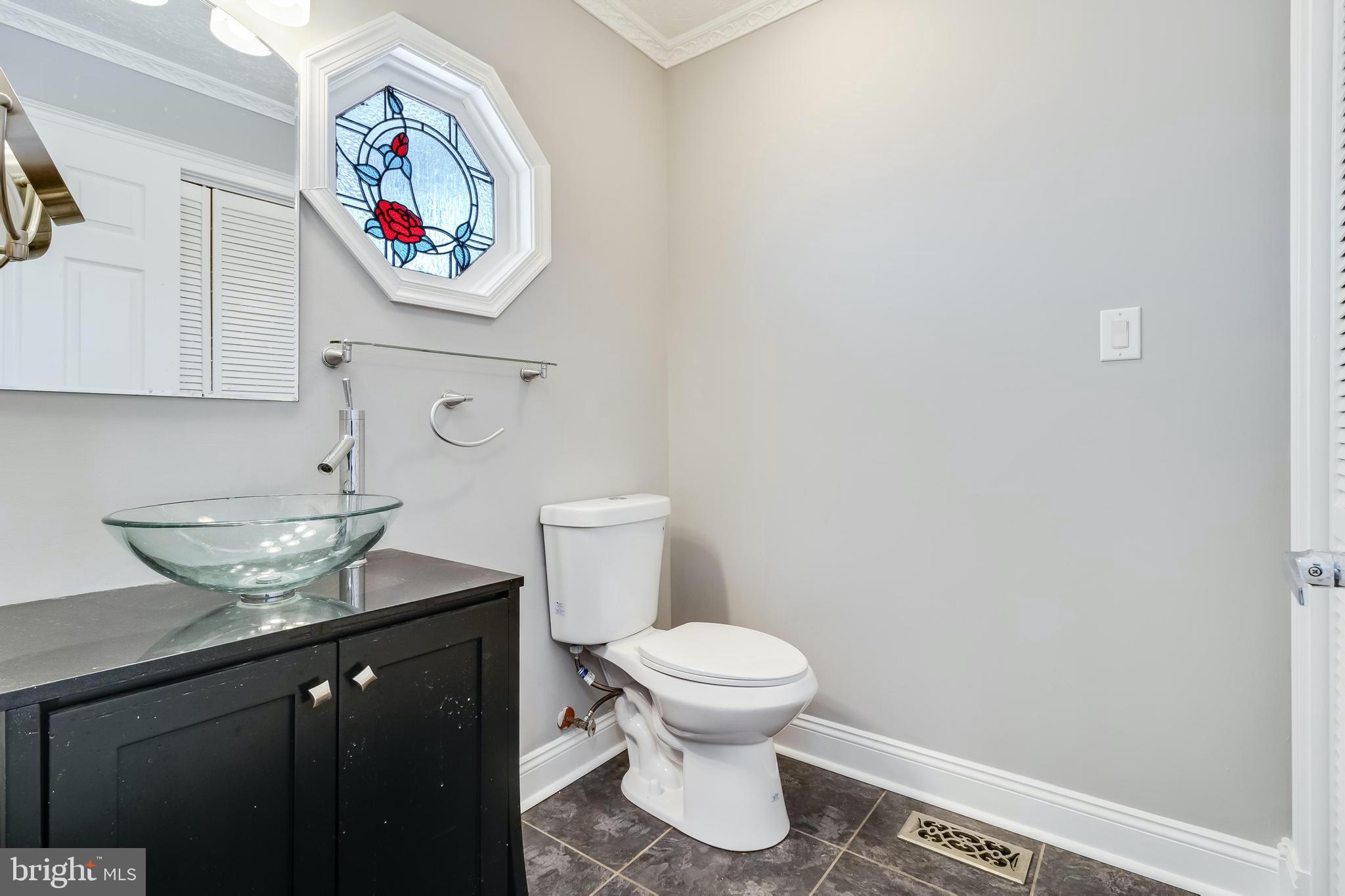 648 Santa Fe Trail Lusby, MD 20657 - Photo 21 of 58 a bathroom with a toilet and a sink