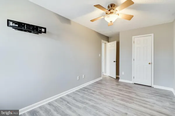 an empty room with wooden floor and entryway
