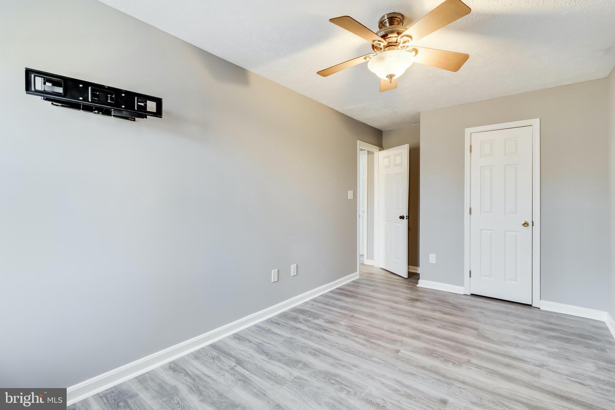 648 Santa Fe Trail Lusby, MD 20657 - Photo 34 of 58 an empty room with a window and a ceiling fan