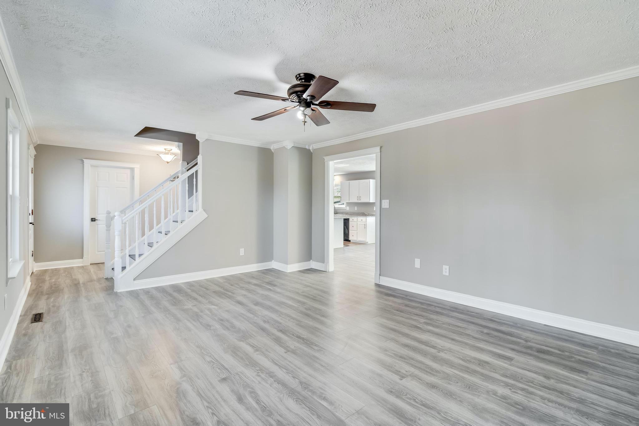 648 Santa Fe Trail Lusby, MD 20657 - Photo 7 of 58 a view of a livingroom with wooden floor and a ceiling fan