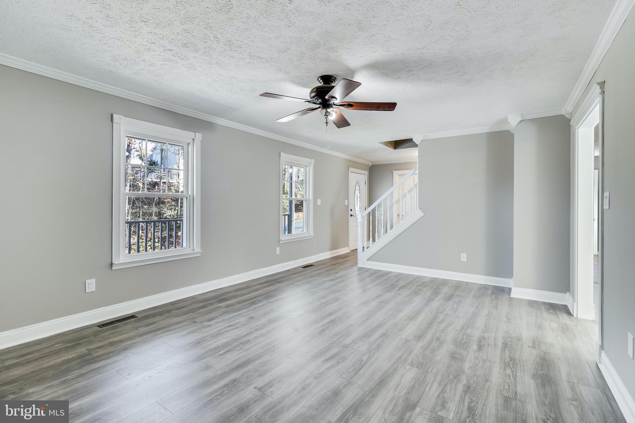 648 Santa Fe Trail Lusby, MD 20657 - Photo 8 of 58 a view of an empty room with a window and wooden floor