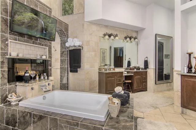 a living room with furniture a flat screen tv and a floor to ceiling window