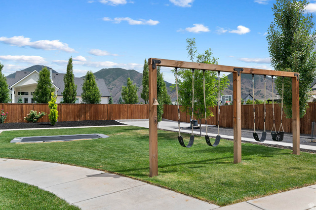 500 North 516th Street West, Unit 19 Mapleton, UT 84664 - Photo 39 of 41 Concrete pathways roll past a built-in trampoline and wood swing set.
