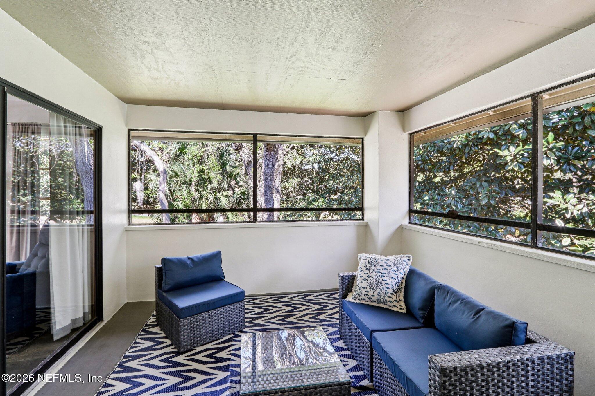 10150 Belle Rive Boulevard, Unit 102 Jacksonville, FL 32256 - Photo 20 of 33 a living room with furniture and a large window