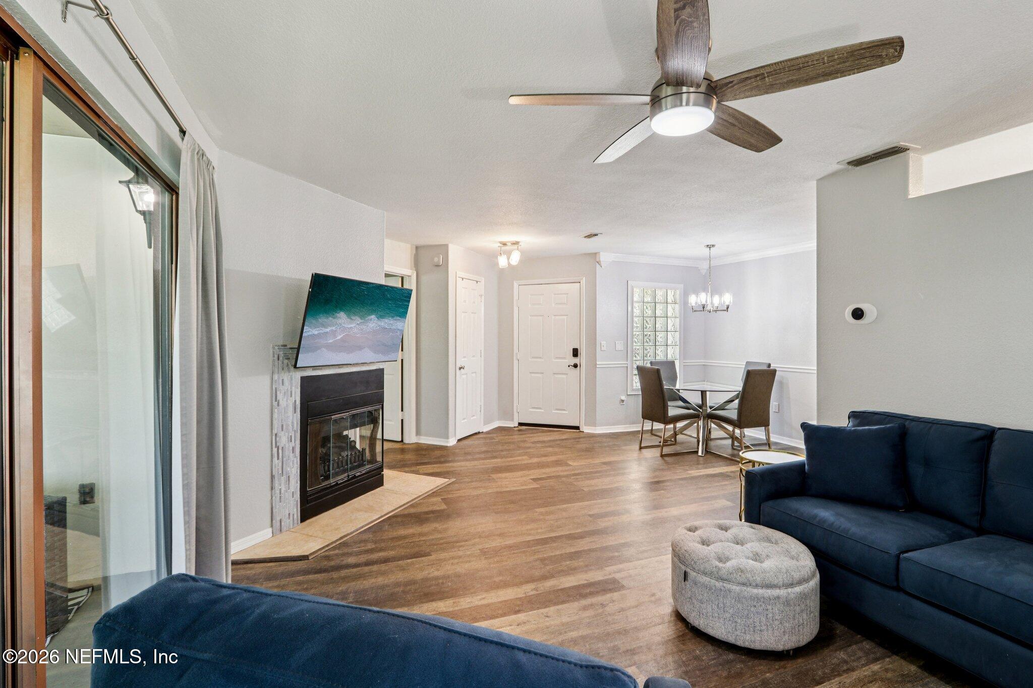 10150 Belle Rive Boulevard, Unit 102 Jacksonville, FL 32256 - Photo 4 of 33 a living room with furniture and a fireplace