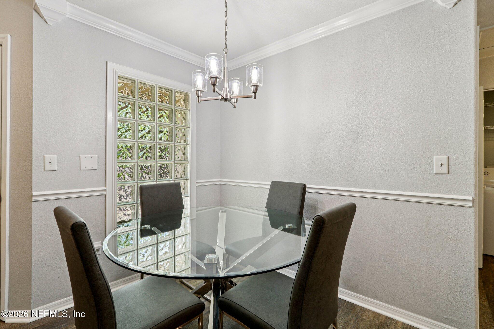 10150 Belle Rive Boulevard, Unit 102 Jacksonville, FL 32256 - Photo 5 of 33 a view of a dining room with furniture window and wooden floor