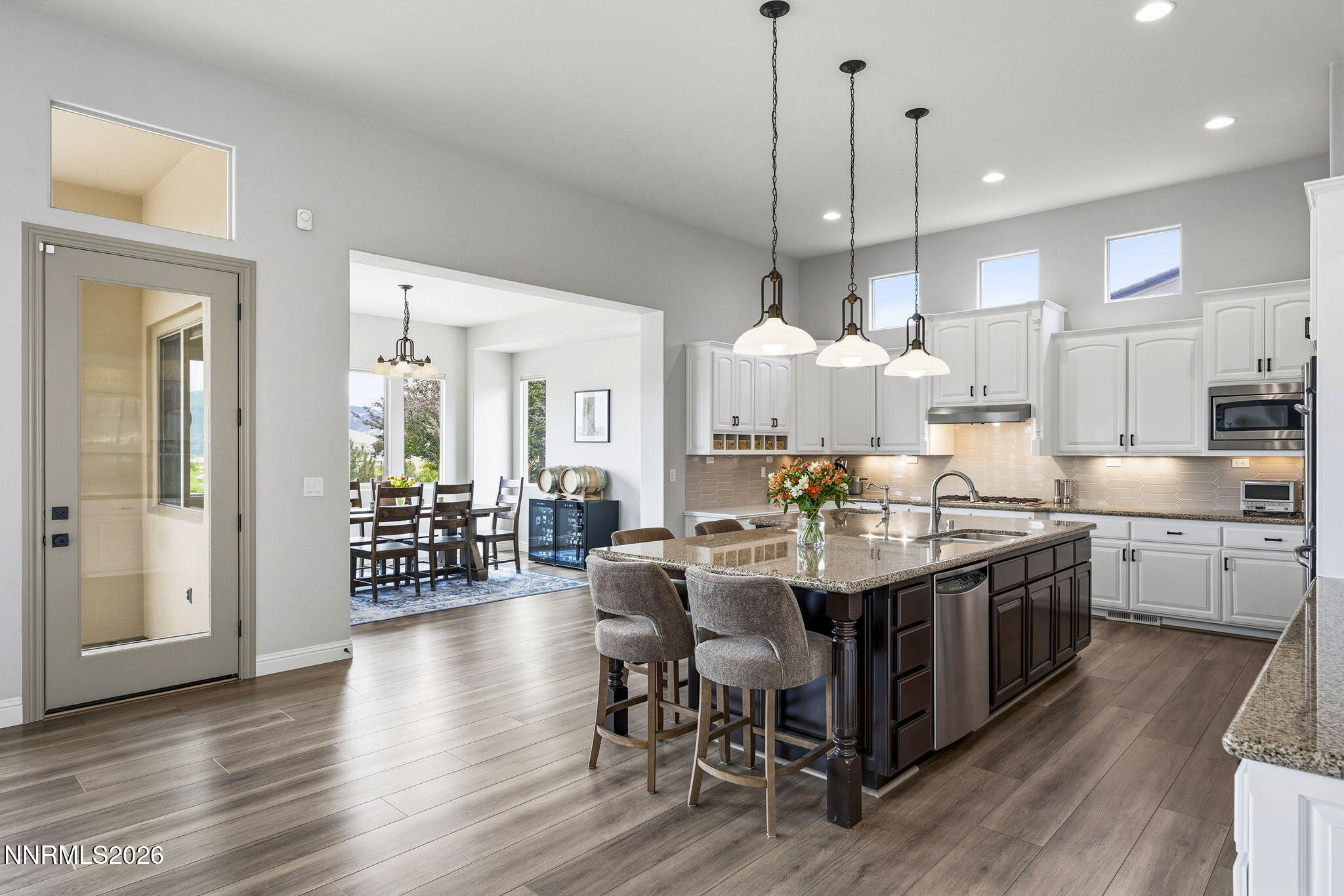 13340 Damonte View Lane Reno, NV 89511 - Photo 12 of 44 a view of a dining room and livingroom with furniture wooden floor a chandelier