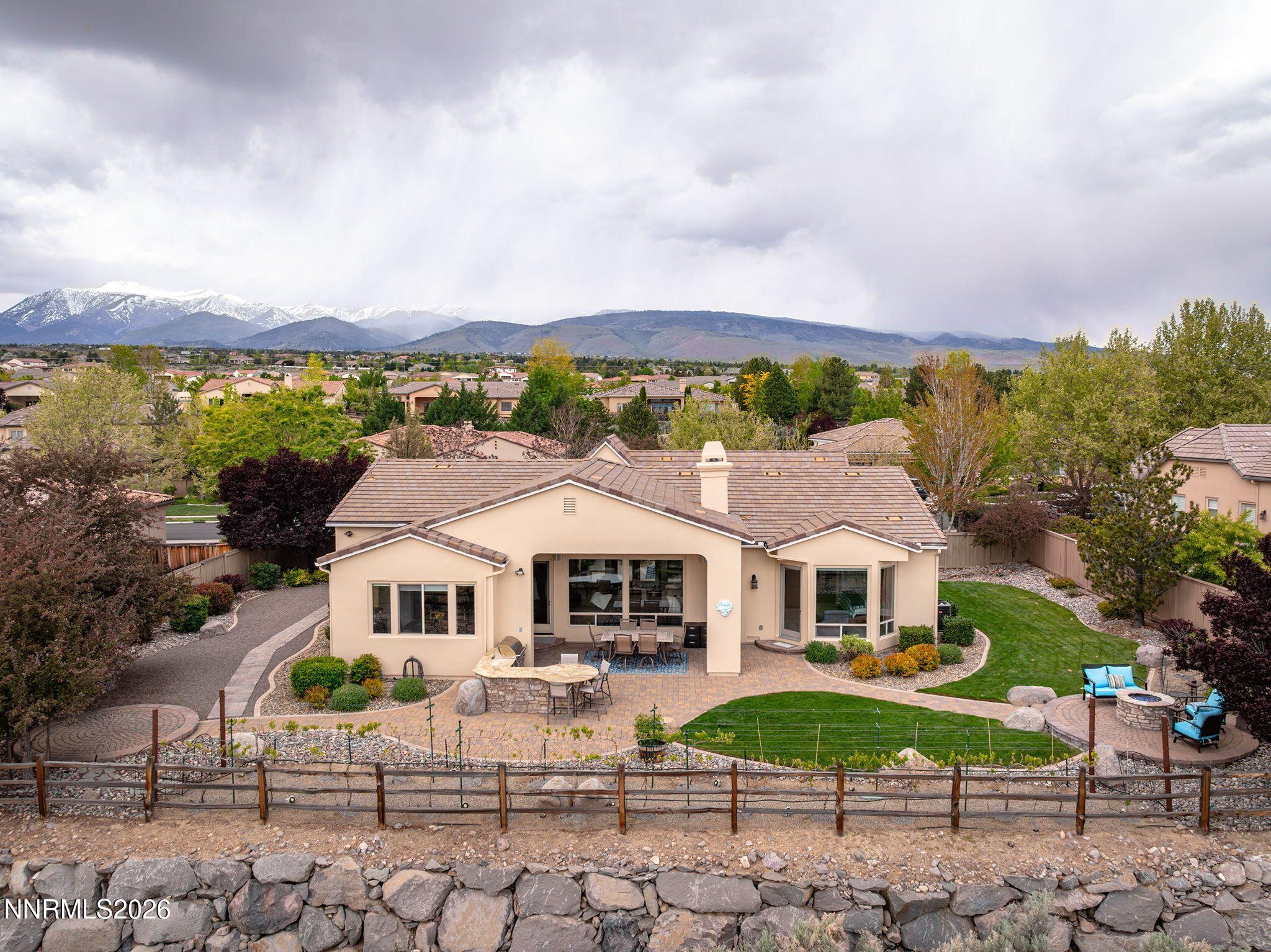 13340 Damonte View Lane Reno, NV 89511 - Photo 35 of 44 a aerial view of a white house with a yard and table and chairs under an umbrella