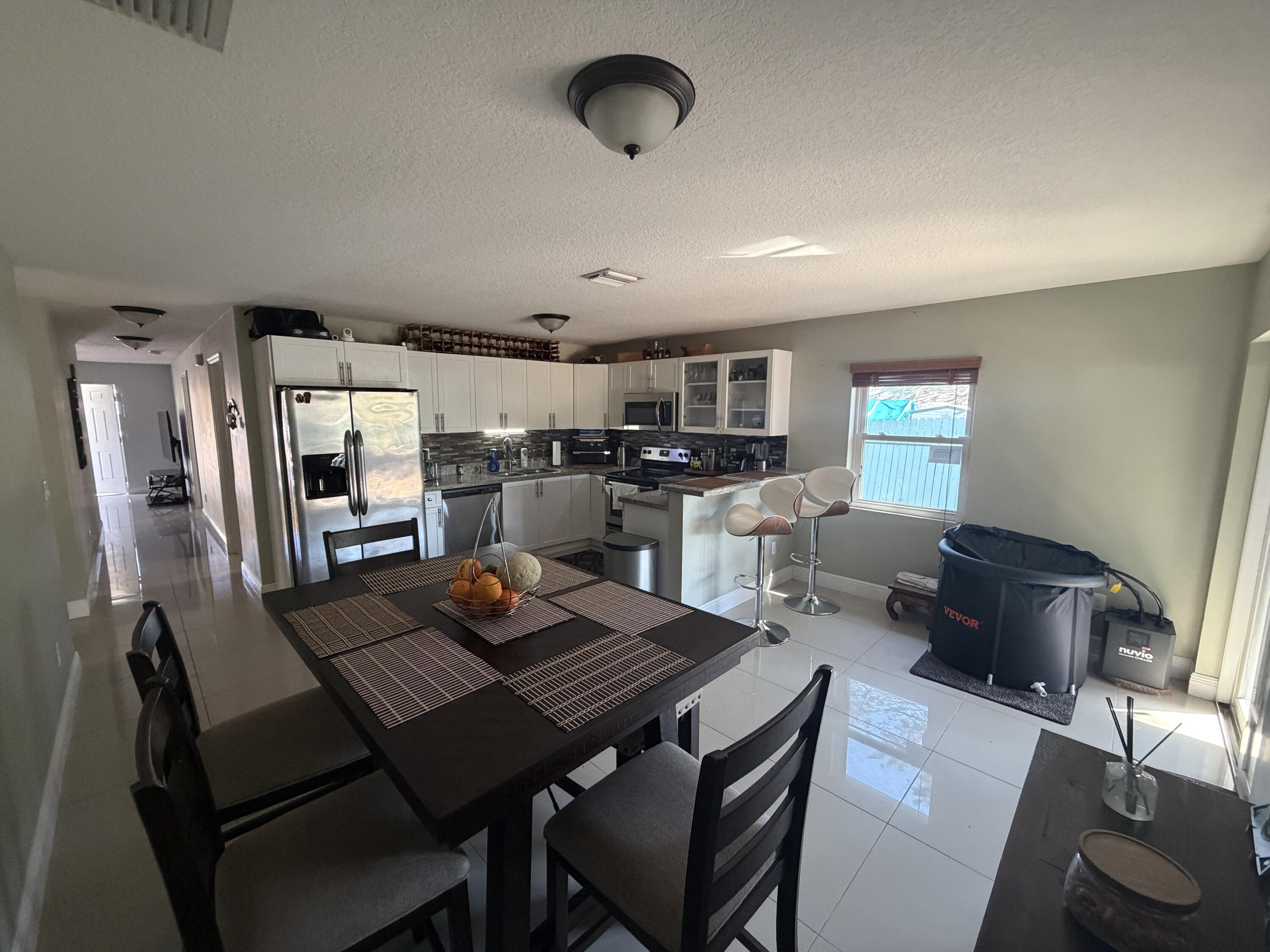 5928 Papaya Road Royal Palm Estates, FL 33413 - Photo 4 of 12 a view of a dining room with furniture