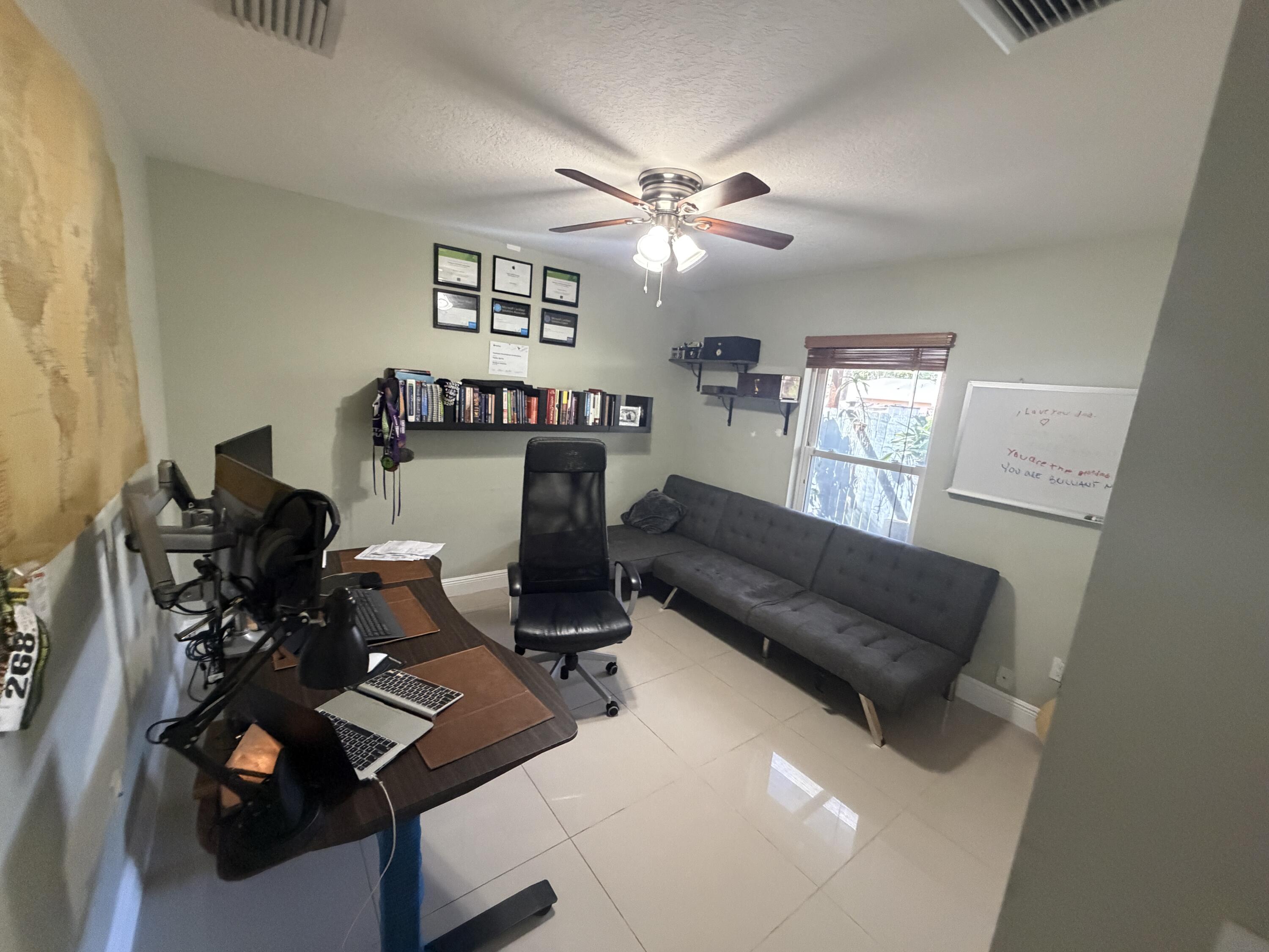 5928 Papaya Road Royal Palm Estates, FL 33413 - Photo 7 of 12 a view of a workspace with furniture and a window