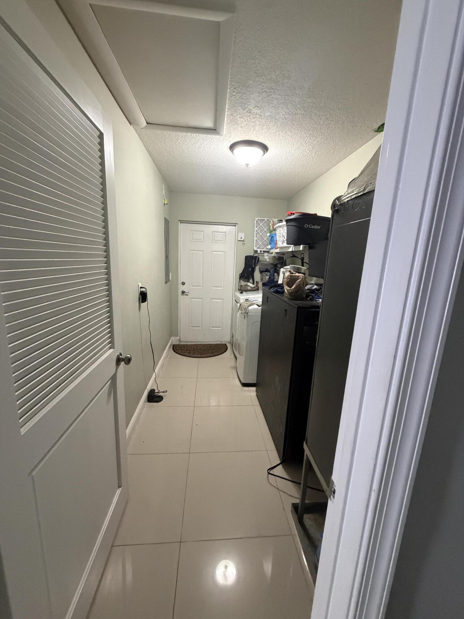 5928 Papaya Road Royal Palm Estates, FL 33413 - Photo 10 of 12 a view of a hallway with storage