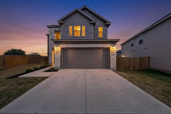 a front view of a house with a yard and garage