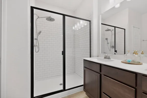 a bathroom with a double vanity sink and mirror