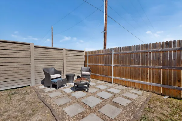 a view of backyard with a chair and the patio