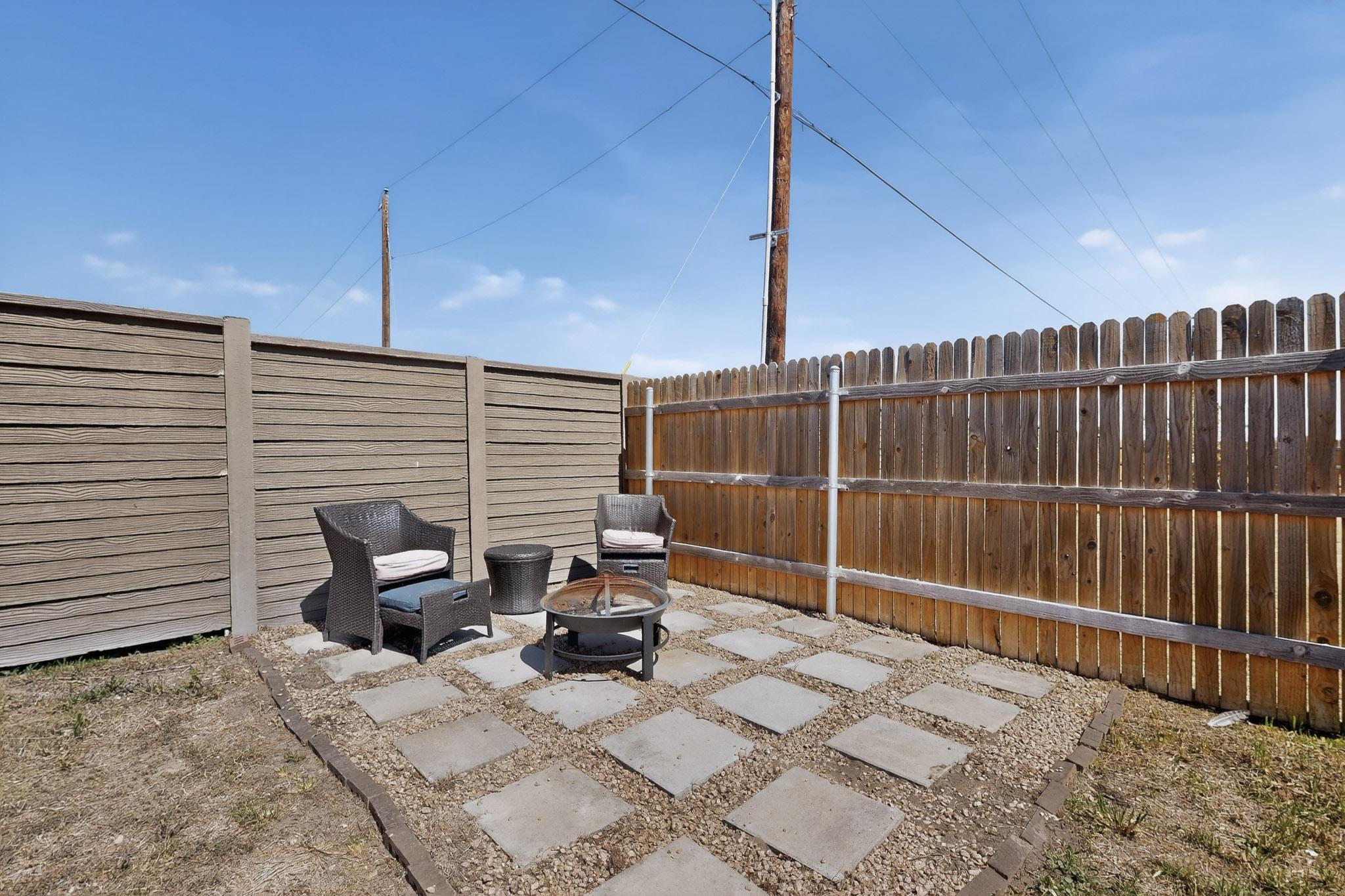 14513 Booted Eagle Pass Elgin, TX 78621 - Photo 31 of 34 a view of backyard with a chair and the patio