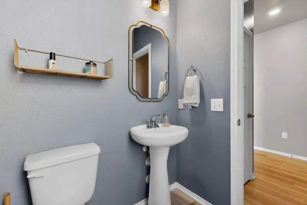 a bathroom with a sink a toilet and mirror