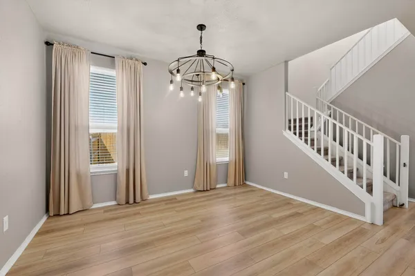 a view of an entryway with wooden floor