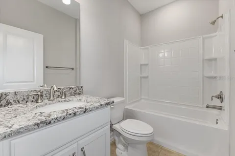 a bathroom with a sink toilet vanity and shower