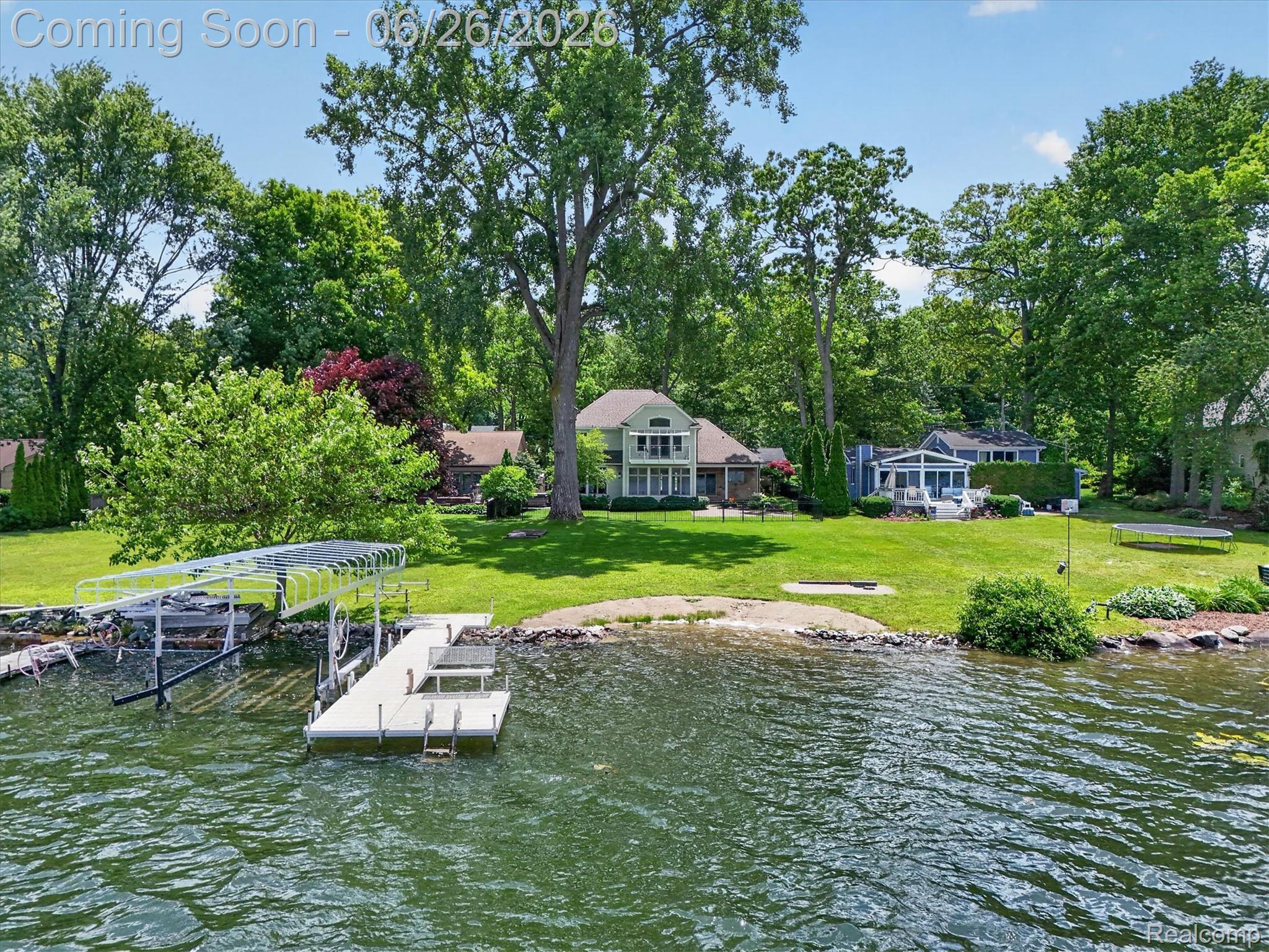 3478 Lexington Road Waterford, MI 48328 - Photo 42 of 52 Waterfront property featuring a private dock, boat lift, and a landscaped shoreline