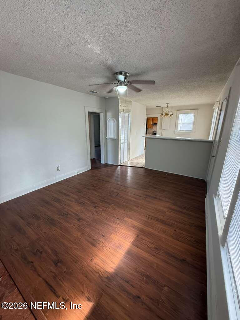 4067 Gilmore Street Jacksonville, FL 32205 - Photo 4 of 10 wooden floor in an empty room with a window