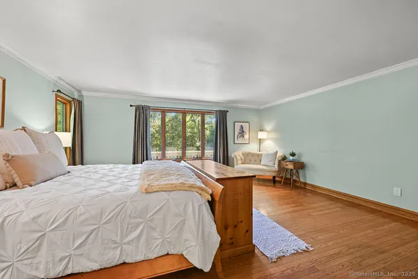 a bed sitting in a bedroom next to a window