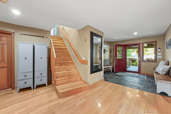 a view of a livingroom with wooden floor and stairs