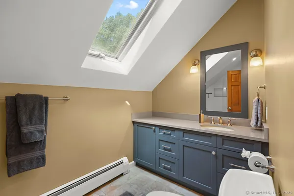 a bathroom with a sink a mirror and a toilet