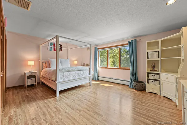 a bedroom with a bed and a window