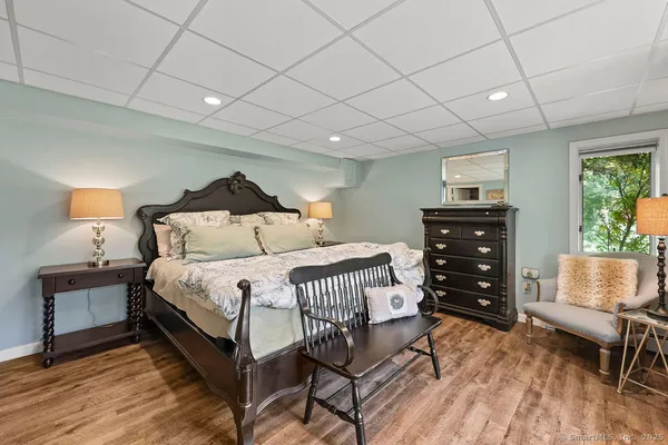 a bedroom with a bed and a chair