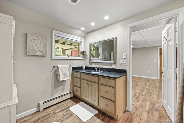 a spacious bathroom with a granite countertop sink a mirror and a