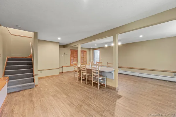 a view of a room with wooden floors and chairs