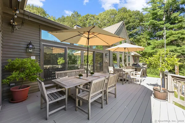 a view of a patio with a dining table and chairs under an umbrella