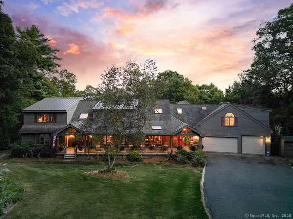 a front view of a house with a yard and a road