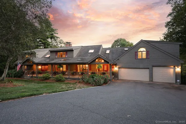 a view of a house with a yard and potted plants