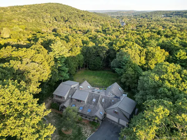 an aerial view of a house with a yard
